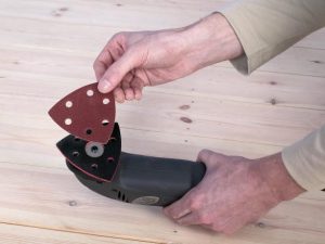 corner sander set up man fitting sandpaper